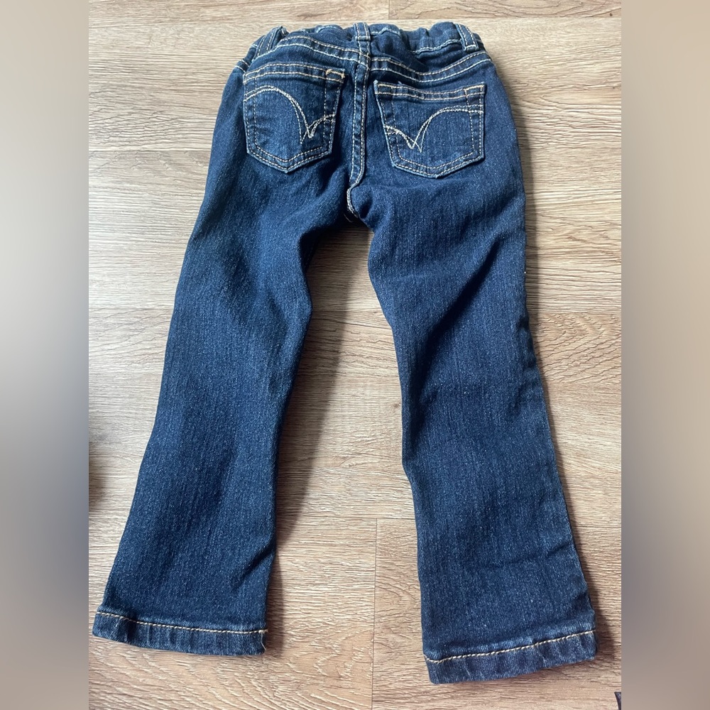 Little girls denim jeans with a dust adjustable waist. Size 2T.